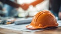Close-up of Hard Hat on Engineer's Desk with Blueprints and Tools Royalty Free Stock Photo