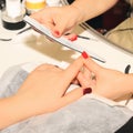 Close-up hardware manicure in salon. Removal of old gel varnish. Manicure master doing beauty procedure for client. Nail care Royalty Free Stock Photo