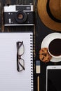 Close-up of hat, notepad, camera, phone, eyeglasses and a cup o Royalty Free Stock Photo