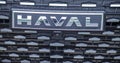 Close-up of the Haval car logo on the radiator grille