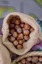 Close-up of hazelnuts as background . Mix of hazelnut with hard shell . dried hazelnuts , closeup . Hazelnuts in a small bag of