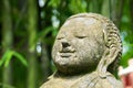 Close up Head Buddha carved from stone in bamboo park