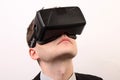 Close-up of a head of a man wearing a VR Virtual reality Oculus Rift 3D headset, looking upwards