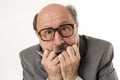 Close up head portrait of bald 60s senior business man surprised and scared looking as if big mistake or disaster in the office Royalty Free Stock Photo