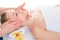 Close up head portrait of young woman having facial massage in s Royalty Free Stock Photo