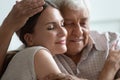 Older hoary man hugging loving grown up daughter at home. Royalty Free Stock Photo