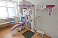 Close up head shot of girl taking dental tac with cephalometric panorama x-ray machine in clinic.