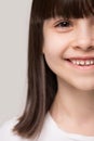 Close up head shot half face smiling little preschool girl. Royalty Free Stock Photo