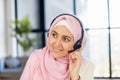 A close up head shot portrait of smiling Arabian woman operator in hijab Royalty Free Stock Photo