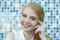 Close up head shot of smiling european blond haired young woman