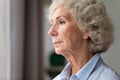 Close up thoughtful older woman looking out window at home Royalty Free Stock Photo