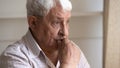 Thoughtful unhappy elder man looking out window. Royalty Free Stock Photo