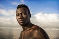 Portrait of young attractive and fit black African American man with strong muscular body posing cool model attitude on the beach Royalty Free Stock Photo