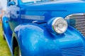 Close up on headlamp of blue vintage Chrysler Royal from 1938