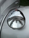 Close up of the headlamp of an elegant silver colored stylish 1930s vintage automobile Royalty Free Stock Photo