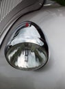 Close up of the headlamp of an elegant silver colored stylish 1930s vintage automobile Royalty Free Stock Photo