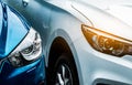 Close up headlamp light of blue and white SUV car. Blue car parked beside white car. Automotive industry concept. Electric car Royalty Free Stock Photo