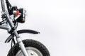 Close up of headlight and front wheel on vintage motorcycle. Custom scrambler motocross. Retro motorbike on white background. Royalty Free Stock Photo