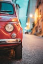 Close Up Headlight Of Old Small Funny Vintage Retro Red Car In Evening Night