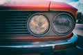 Close-up of headlight of a red vintage classic car Royalty Free Stock Photo