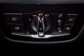 close-up of Headlights control unit with buttons for controlling headlights, fog lamps, parking lights and dimming the dashboard Royalty Free Stock Photo
