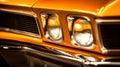 a close up of the headlights of an orange muscle car Royalty Free Stock Photo