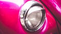 Close-up of headlights of pink vintage car Royalty Free Stock Photo