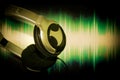 Close up Headphone, earphone hung on sound wave screen background Royalty Free Stock Photo