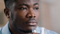 Close up headshot african millennial man drink pure fresh cold water glass healthy liquid suffer from hot make daily Royalty Free Stock Photo