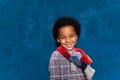 Stylish laughing black kid in casual clothes with curly afro hair