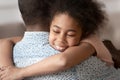 Close up headshot little black girl cuddling father. Royalty Free Stock Photo