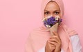 Close-up portrait of young charming Arab Muslim woman in pink hijab with beautiful dark eyes, attractive gaze, looking at camera, Royalty Free Stock Photo