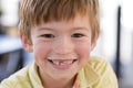 Close up headshot portrait of young little 7 or 8 years old boy with sweet funny teeth smiling happy and cheerful in joy face expr Royalty Free Stock Photo