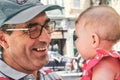 Close-up headshot of a white Caucasian mature father grandfather playing with a cute baby girl toddler Royalty Free Stock Photo