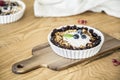 Close-up of a healthy breakfast of oatmeal and raisins with yoghurt on a wooden table