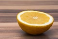 Close up of healthy citrous fruit, half of yellow lemon on a wood table