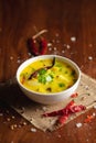 Close-up of healthy curry of yogurt and potato Dahi Aloo or Aaloo an Indian Classical dish. Served in white ceramic bowl.