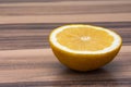 Close up of healthy half of yellow lemon on a wooden table