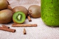 Close-up of healthy kiwis. Juice with cinnamon and fruits on a fabric background. Vegan ingredients. Refreshing snacks.