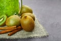 Close-up of healthy kiwis. Juice with cinnamon and fruits on a gray background. Vegan ingredients. Refreshing summer