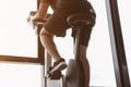Close up healthy legs is riding a spin bike in gym. Fitness man is doing cardio exercise on cycling bikes.