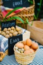 Close-up of healthy organic produce eggs and potatoes on farm market in baskets Royalty Free Stock Photo