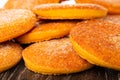 Close up of heap orange cookies on wooden table