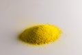 Close up of heap of yellow sand and copy space on white background