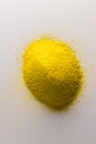 Close up of heap of yellow sand and copy space on white background