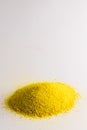 Close up of heap of yellow sand and copy space on white background