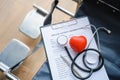 Close up heart ball and stethoscope on empty wheelchair