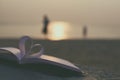 Close up heart book on sand in the beach with vintage filter blur background Royalty Free Stock Photo