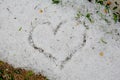CLOSE UP HEART DRAWING ON LARG FRESHLY HAIL STONES IN GRASS Royalty Free Stock Photo