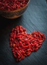 Close-up of heart shaped dried goji berries on dark background Royalty Free Stock Photo